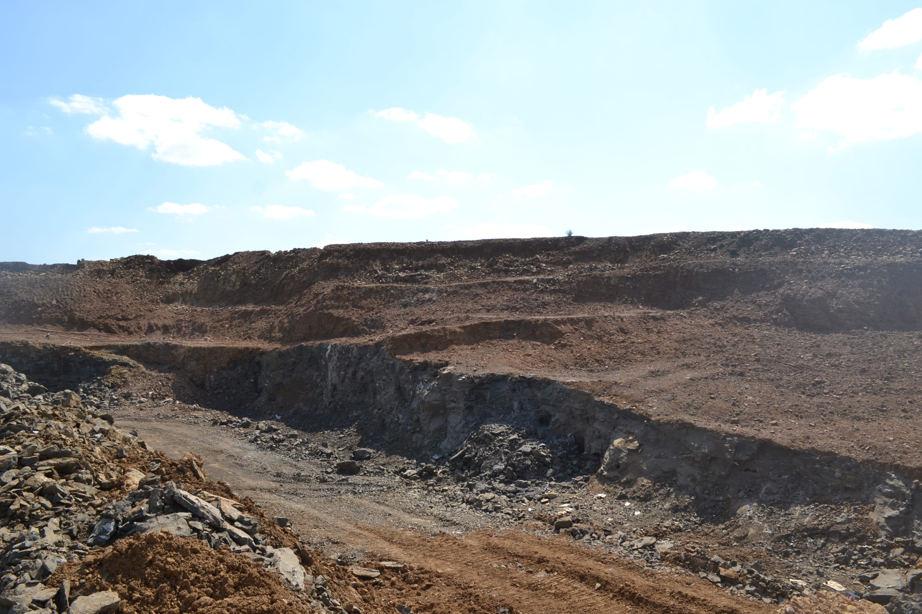 Panoramic view of a quarry in Los Catalanes: the face of rock and soil under the sky