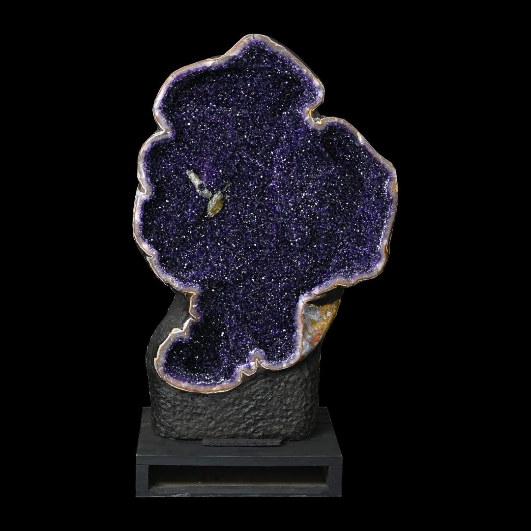 A lobed amethyst geode on a dark base